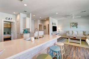 a kitchen and living room with a counter and a couch at Beachy Keen in Port Aransas