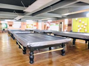 a row of ping pong tables in a room at Hotel EC Double Star KLIA 1-KLIA 2 in Sepang