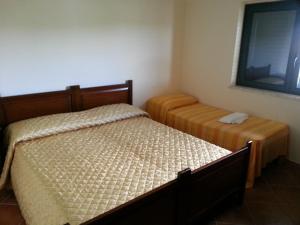 a bedroom with two twin beds and a window at San Nicola Il Sole in Albanella +3 photos