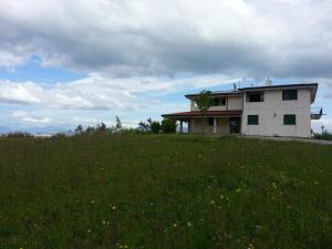 a house sitting on top of a grassy field at San Nicola Il Sole in Albanella