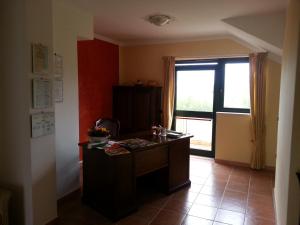 a room with a desk and a large window at San Nicola Il Sole in Albanella