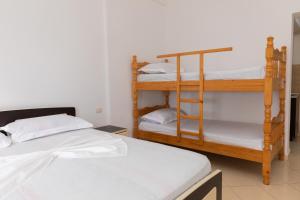 a room with two bunk beds and a room withthritisthritisthritisthritisthritisthritis at Sulo Villa in Vlorë +46 photos