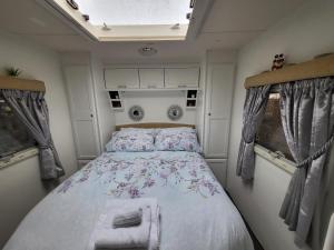 a bedroom with a bed in a small room at Glamping with Llamas in Wisbech