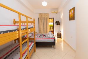 a bedroom with two bunk beds and a balcony at Sulo Villa in Vlorë