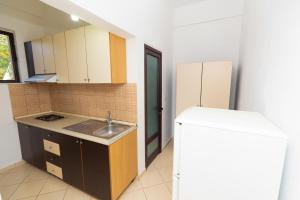 a small kitchen with a sink and a refrigerator at Sulo Villa in Vlorë