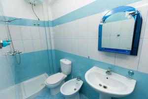 a bathroom with a toilet and a sink and a mirror at Sulo Villa in Vlorë