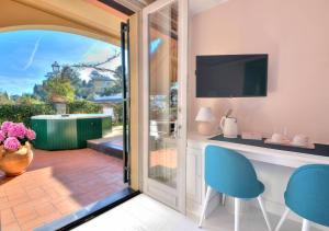 an open door to a patio with a table and chairs at Villa Mares - sea view, free garage in Rapallo