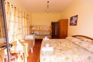 a small bedroom with a bed and a table at Sulo Villa in Vlorë