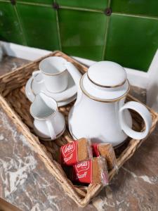 a basket with a tea pot and cups and bread at Cosy Cottage in Central Reading Free Parking & Fast Wifi in Reading