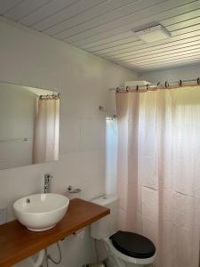 a bathroom with a sink and a toilet at Agüita de Coco in Barra del Chuy