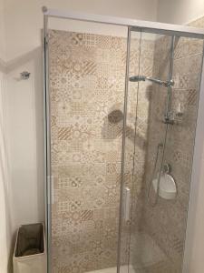 a shower with a glass door in a bathroom at CASA TUA in Ivrea