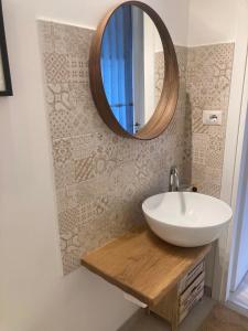 a bathroom with a sink and a mirror on the wall at CASA TUA in Ivrea