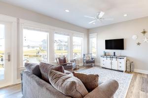 a living room with a couch and a flat screen tv at Dolphin View in Rockport