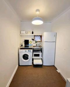 a kitchen with a white refrigerator and a washing machine at Sinchon station 4 min three-room hongdae in Seoul