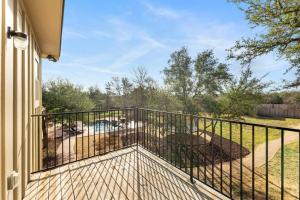 a balcony with a fence on a house at Peaceful Hill Country Oasis in Kyle