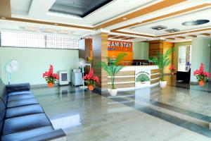 a lobby of a dental office with a exam sign and plants at SV Dreamstay near Kempegowda International Airport in Yelahanka