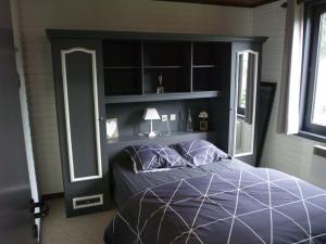 a bedroom with a large bed with a large headboard at Chalet Balthazar in Durbuy