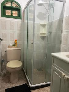 a bathroom with a shower with a toilet and a sink at Suíte Pontal in Arraial do Cabo +23 photos