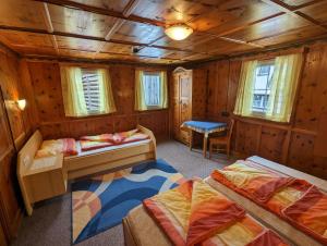 a bedroom with two beds in a wooden cabin at Ferienhaus Fatlar in Kappl