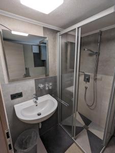 a bathroom with a glass shower and a sink at Ferienhaus Fatlar in Kappl