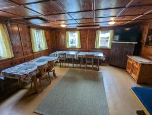 a dining room with tables and chairs in a cabin at Ferienhaus Fatlar in Kappl