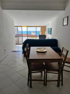 uma sala de estar com uma mesa e um sofá azul em SEA VIEW ALBUFEIRA Center CERRO BRANCO em Albufeira