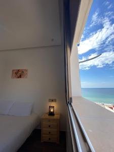 a bedroom with a bed and a view of the ocean at Tourma House in Taghazout