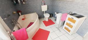 a bathroom with a tub and a toilet and a sink at Nyaralóház HANGA in Fonyód +17 photos