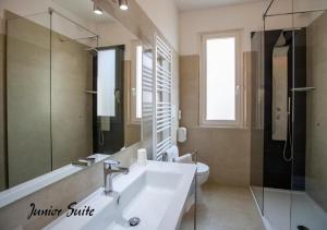 a bathroom with a sink and a toilet and a mirror at Hotel Lory My Wellness SPA in Chianciano Terme