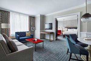 a hotel room with a king bed and a living room at The Ritz-Carlton, Washington, D.C. in Washington, D.C.