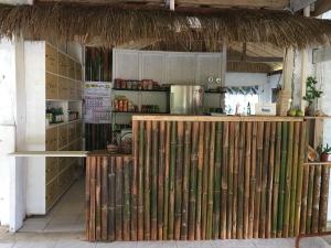 a kitchen with a bunch of wooden dividers in a room at Bohol Hammock Hostel in Batuan