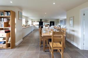 a dining room and kitchen with a table and chairs at Luxury 5 bedroom house - sleeps 10 in Colkirk