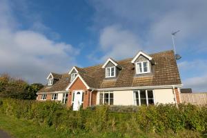 a house with a brown roof at Luxury 5 bedroom house - sleeps 10 in Colkirk