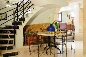 a dining room with a staircase leading up to a balcony at Hotel Balear in Can Pastilla