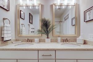 a bathroom with two sinks and two mirrors at 4 Bed 35 BA 1K 3Q 2T Sleeper Sofa Park 3 Cars Bikes & Beach Gear included in Hilton Head Island +27 photos