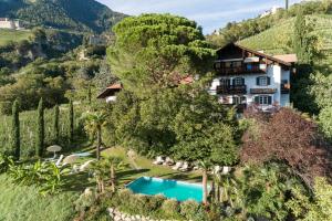 an aerial view of a villa with a swimming pool at Matailerhof in Tirolo