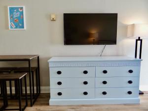 a white dresser with a television on top of it at Sunset Seaview-21103 in Myrtle Beach