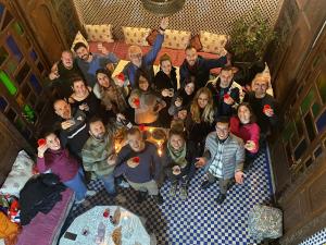 a group of people posing for a picture in a room at Riad Dar Rabha in Fez