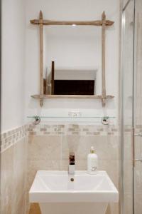 a bathroom with a sink and a mirror at Princes Villa - large fully Self Contained Flat, 5 minutes from the sea in Hastings