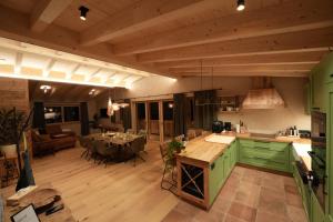 a kitchen with green cabinets and a table in it at Löberbauer, Ferienwohnung in Tux