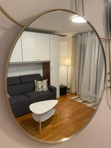 a living room with a couch and a table in a mirror at Studio Centre Ville in Nice