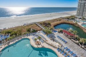 an aerial view of a resort with a swimming pool and the beach at Sea Watch Resort in Myrtle Beach