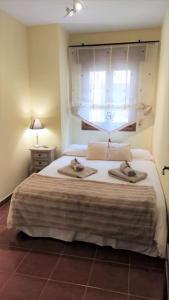 a bedroom with a bed with two towels on it at Apartamento en Navacerrada in Navacerrada
