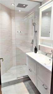 y baño con ducha, lavabo y espejo. en Apartamento en Navacerrada, en Navacerrada