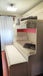 a room with three bunk beds with a pillow at Apartamento en Navacerrada in Navacerrada