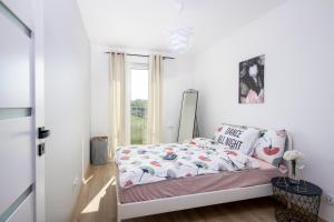 Posteľ alebo postele v izbe v ubytovaní Apartamenty Marii Konopnickiej Kraków