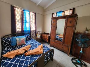 Schlafzimmer mit einem Bett, einer Kommode und einem Spiegel in der Unterkunft La Kaye Nou by SMO Wellness in Soufrière