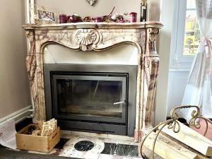 a fireplace with a wooden frame in a living room at Appartement de standing à Vallorbe in Vallorbe