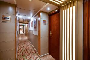 a hallway with a door and a walkway with a hallwayngthngthngthngth at Nile Treasure Cruise - 4 or 7 Nights From Luxor each Saturday and 3 or 7 Nights From Aswan each Wednesday in Luxor