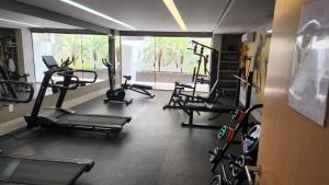 a gym with several tread machines in a room at COBERTURA VISTA MAR in João Pessoa